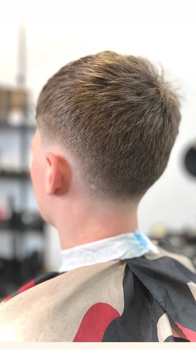 Short taper fade with a clean neckline, back view